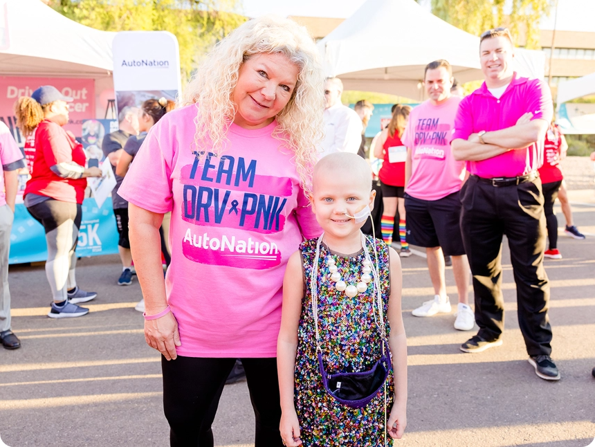 A woman standing next to a little girl